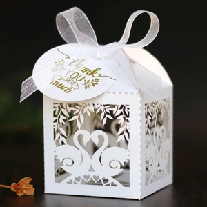 White laser cut swan favor box with heart patterns and Thank You gift tag for weddings