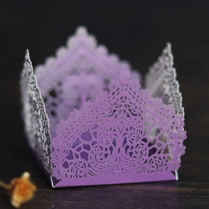 Detailed laser-cut purple paper favor box featuring intricate floral lace patterns for weddings