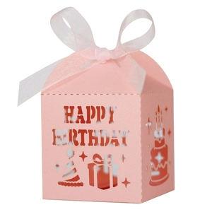 Detail of pink laser-cut Happy Birthday candy box with white ribbon and hollow patterns