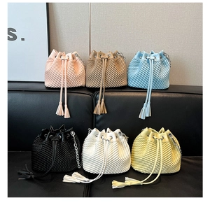 Collection of textured bucket bags with drawstring tassels and gold chain straps