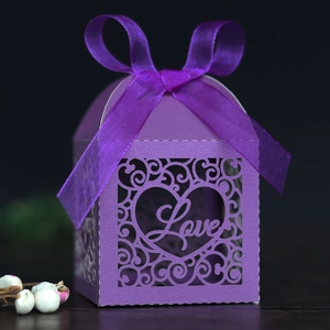 Intricate laser-cut purple gift box detail with Love heart pattern and satin ribbon