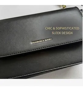 Detail of black pebbled leather bag with gold Fashion & Bags logo and fine stitching