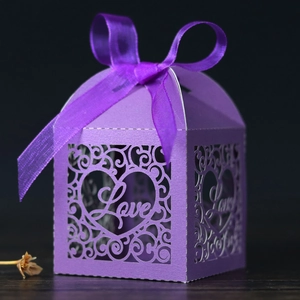 Macro detail of purple laser-cut candy box with Love heart design and satin ribbon