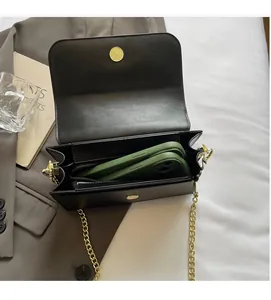 Interior view of black leather square bag showing capacity for two smartphones