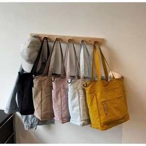 Detail view of multi-color high-capacity nylon tote bags with functional side pockets