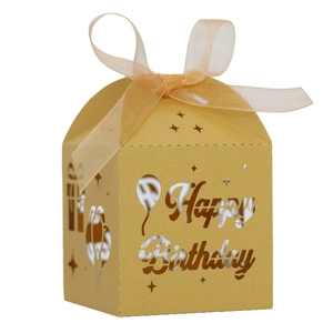 Close-up of golden hollow Happy Birthday candy box with glitter finish and satin ribbon