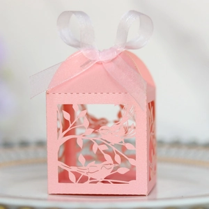 Detail of laser-cut love bird candy box with pearlescent pink paper and white ribbon bow