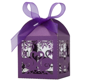 Detail of purple laser-cut candy box featuring elegant swan motifs and a ribbon bow