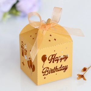 Detailed laser-cut champagne gold Happy Birthday candy box with ribbon and stars