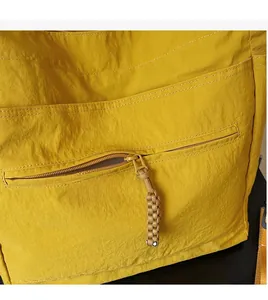 Detailed macro view of yellow waterproof nylon fabric and smooth zipper with woven puller