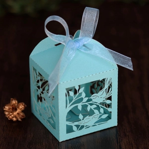 Detailed laser-cut love bird design on light blue wedding candy gift box with ribbon