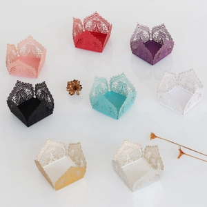 Close-up of laser-cut lace pattern on multicolored wedding candy box wrappers