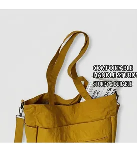 Close-up of vibrant yellow nylon tote bag featuring functional multiple exterior pockets