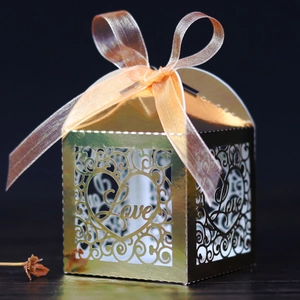 Detailed laser-cut pattern and Love text on gold pearlescent wedding favor box