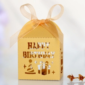 Detailed laser-cut Happy Birthday candy box in bright yellow with a ribbon bow