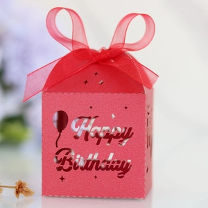 Detail of red hollow Happy Birthday gift box with balloon patterns and mesh bow