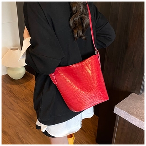 Close-up of red crocodile-pattern bucket bag with premium leather texture and strap