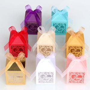 Detail showing various colors of laser-cut heart candy boxes with Love text and organza ribbons