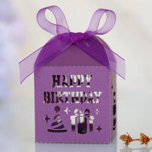 Detail of purple laser-cut Happy Birthday candy box with ribbon and hollow out patterns