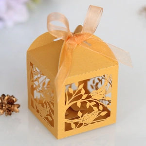 Laser-cut wedding candy box with bird pattern, orange pearlescent paper, and silk ribbon