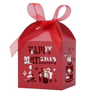 Detail of red laser-cut candy box with Happy Birthday text and organza ribbon