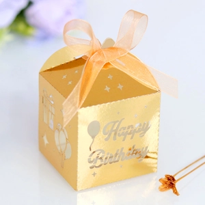 Detailed laser cut Happy Birthday candy box with gold hollow pattern and orange ribbon bow