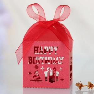 Detail of red laser-cut candy box with Happy Birthday text and silk ribbon bow