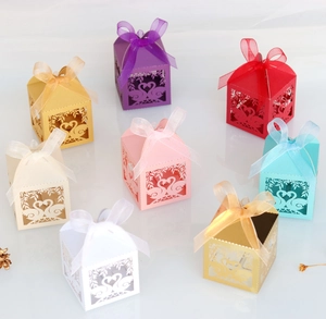 Laser cut favor boxes in multiple colors featuring elegant swan and floral hollow designs