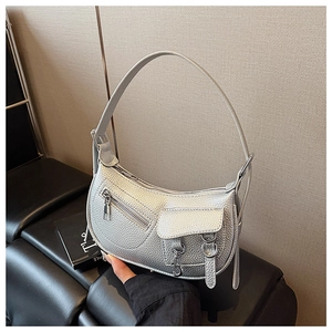 Detailed close-up of metallic silver crescent bag featuring litchi texture leather