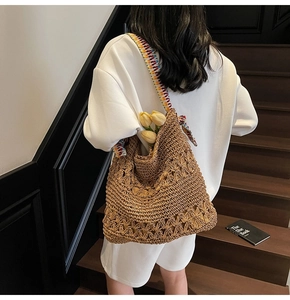 Detailed look at the hollow knit texture and colorful strap of this woven tote bag