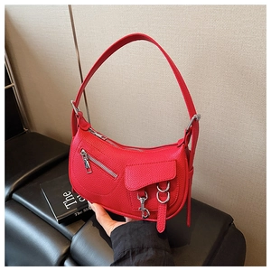 Detailed view of red lychee grain leather handbag with silver metallic hardware accents