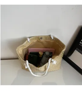 Spacious straw tote interior with cotton rope handles and magnetic closure