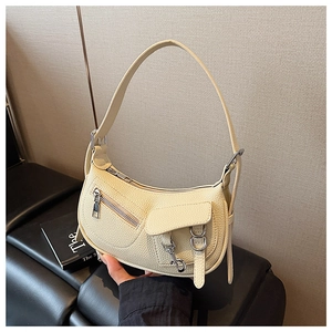 Close-up of beige lychee grain faux leather texture and silver zipper detail on hobo bag