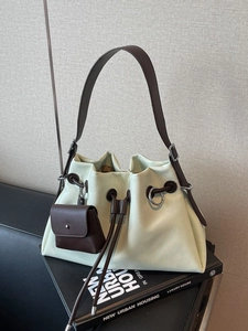 Minimalist beige bucket shoulder bag with brown drawstring and detachable coin purse