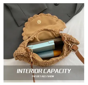 Detail view of woven saddle bag interior with brown leather strap and daily essentials