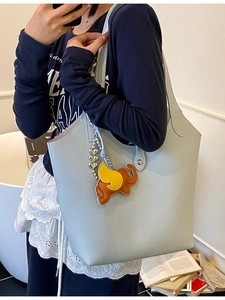 Large light blue lychee pattern leather tote bag with elephant charm and shoulder straps