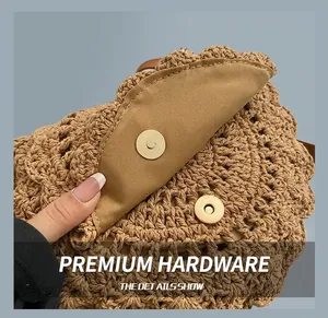 Close-up of golden magnetic snap closure on a brown woven crochet shoulder bag detail