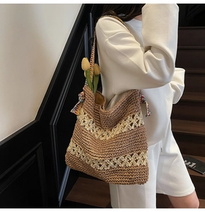 Macro view of woven tote bag showing hollow floral patterns and ethnic shoulder strap