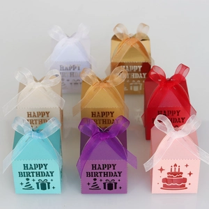 Detail showing eight colors of laser-cut Happy Birthday candy boxes with organza ribbons