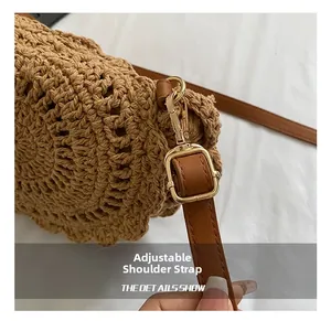 Detail showing adjustable brown leather shoulder strap with gold metal buckle on knit bag