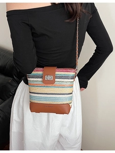 Colorful woven straw bucket bag with leather flap and metal chain strap for beach holidays