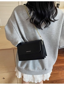 Classic black leather crossbody bag with gold chain strap and fashion lettering logo