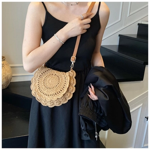 Detail of hand-woven saddle bag featuring elegant ruffled edges and slim brown strap