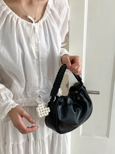 Chic black pleated cloud bag with woven handle and pearl heart charm for woman