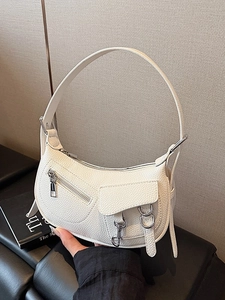 White crescent leather shoulder bag with moto style buckles and pebbled texture