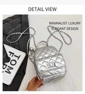 Detail view of silver quilted mini backpack with metallic chain and turn-lock closure