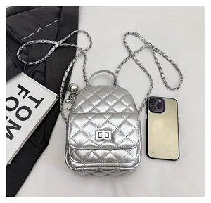 Mini silver quilted backpack with metal chain strap and spherical charm detail