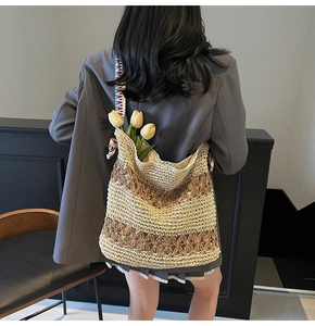 Detail of hand-woven straw tote with colorful ribbon strap and hollow texture