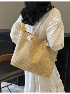 Straw tote bag for women with white rope straps and fringe details on white dress