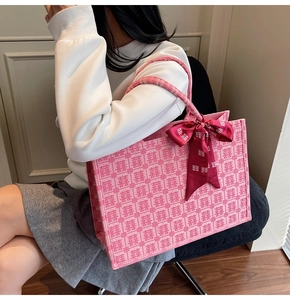 Detail of pink bridal tote bag with traditional double happiness pattern and red silk scarf